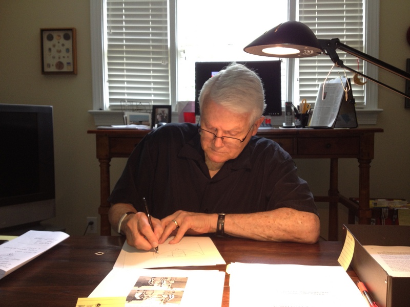 Coach Lee Rose at his desk, drawing plays